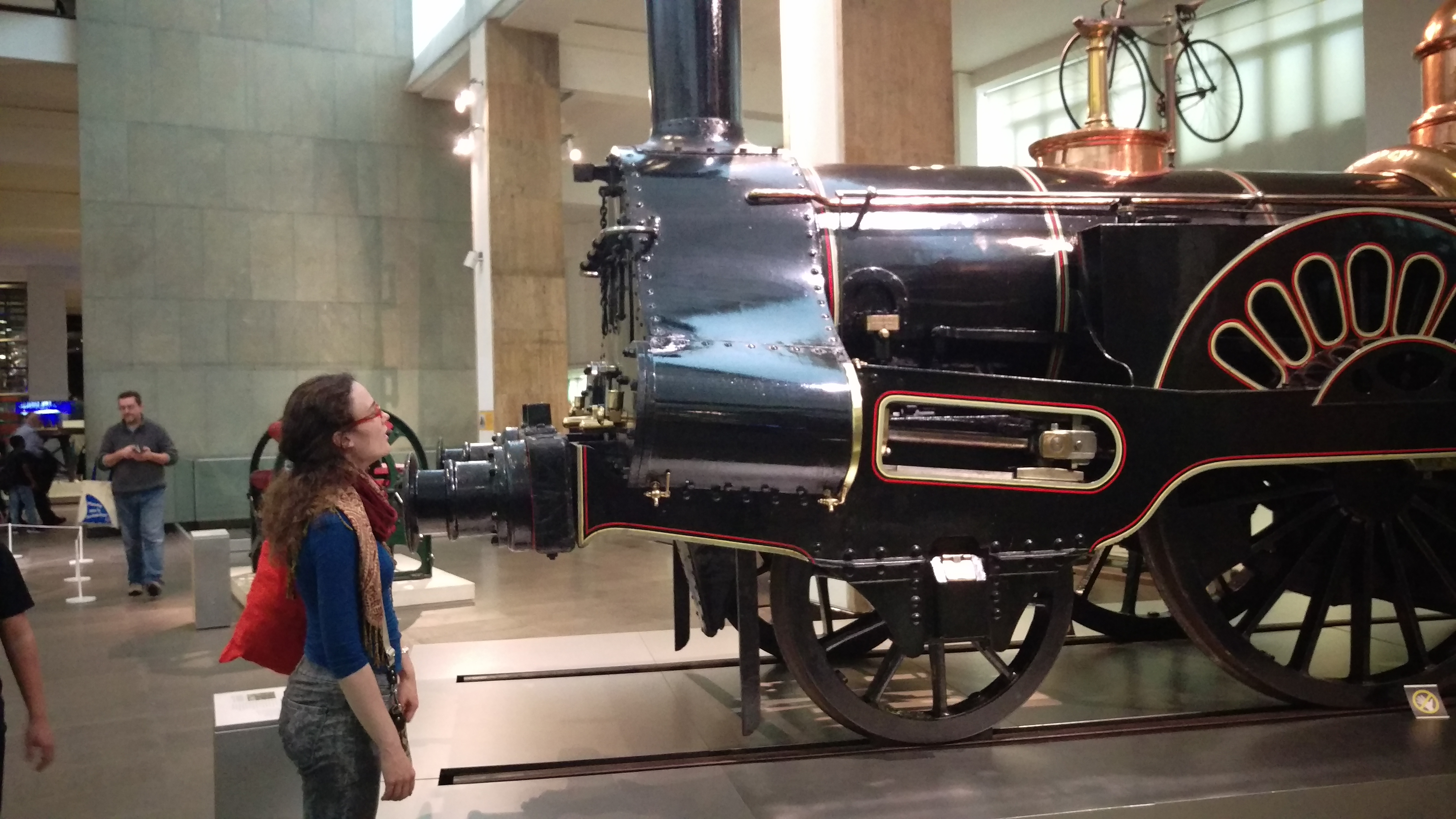 A photo of me, starting with mouth agape at a train from the industrial revolution era in the London Science museum